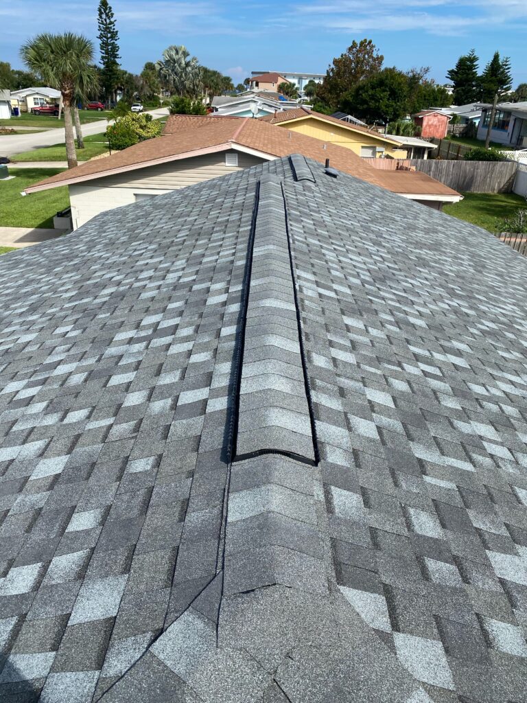Completed Ormond By-the-Sea Florida roof replacement for an out-of-state homeowner, with Atlas Pinnacle Pristine shingles in Coastal Granite